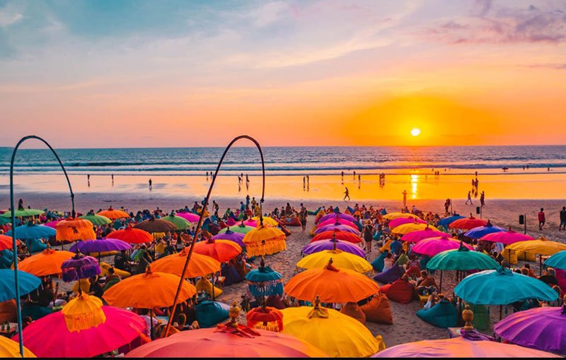 Golden sunset at Seminyak Beach with people walking along the shoreline